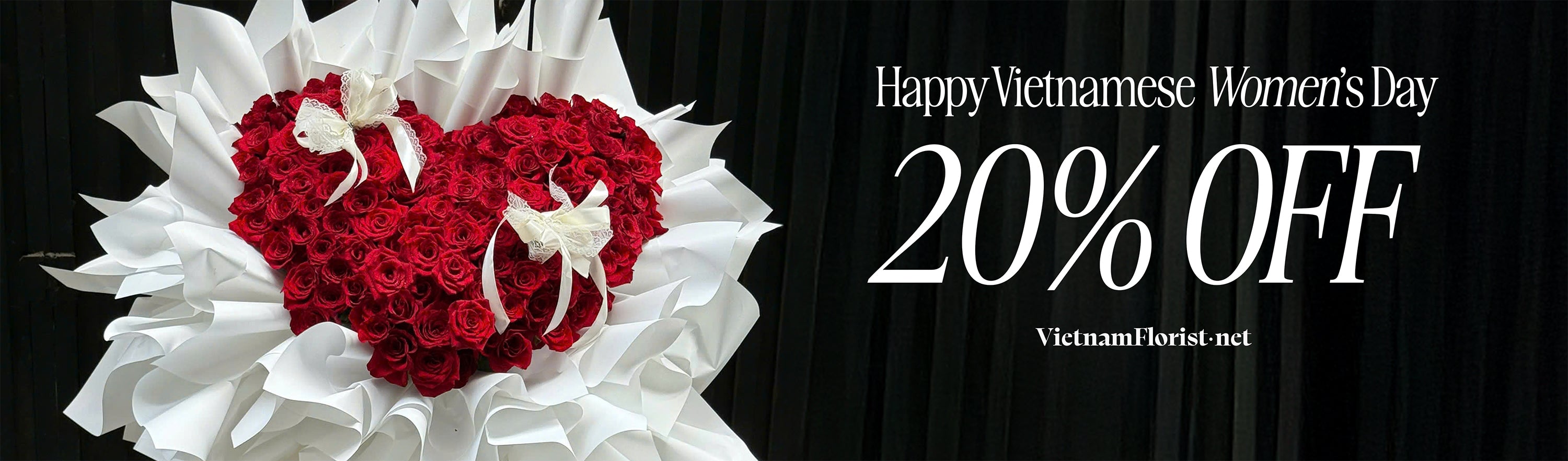 Floral arrangement with red heart and white flowers, promotional text for Vietnamese Women's Day discount on a black background.